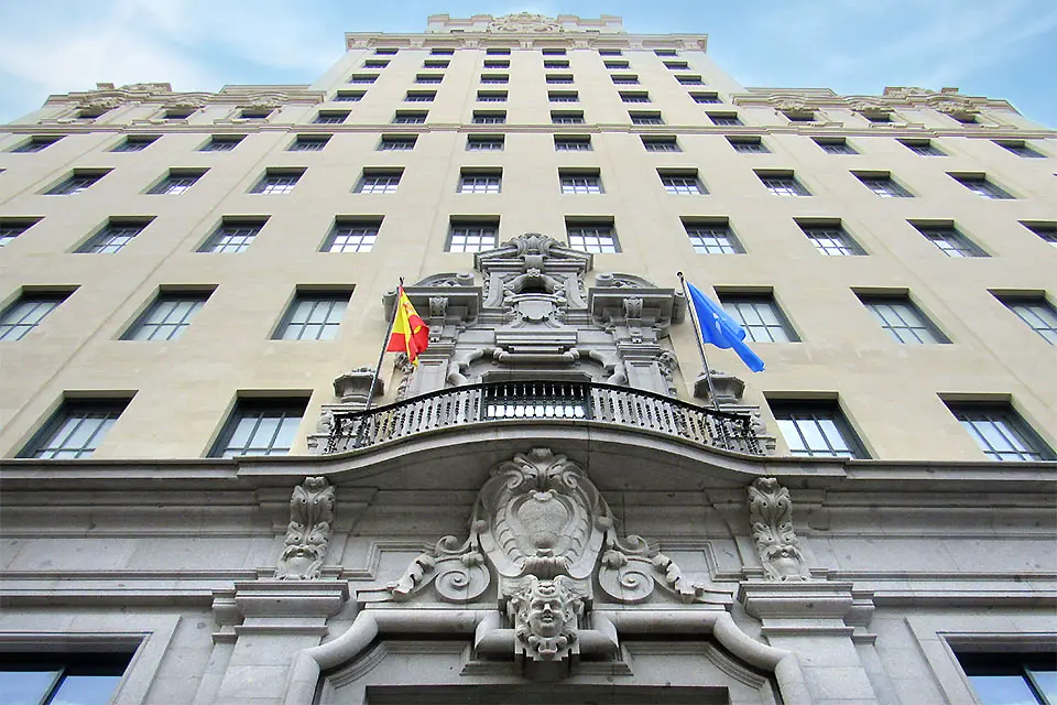 Exterior image of the front of the museum, looking straight up the facade toward the sky.