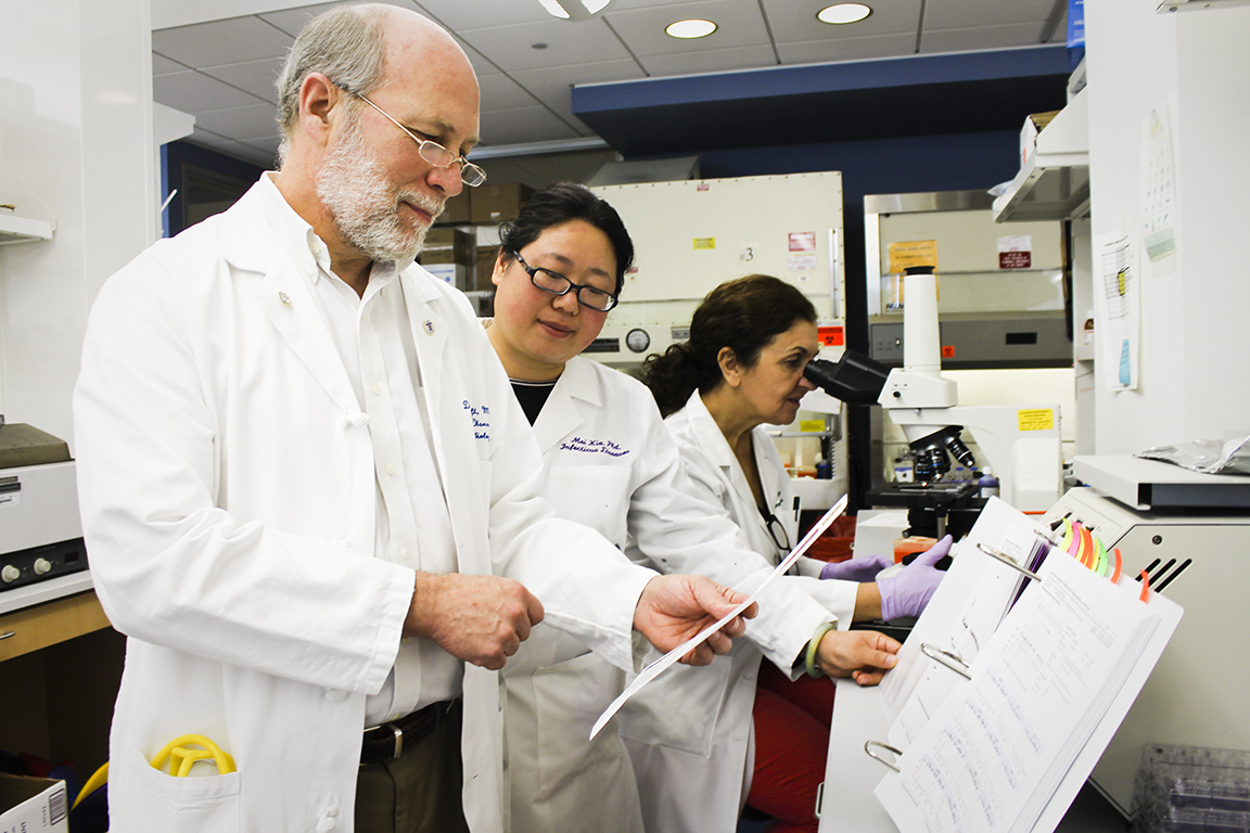 Director of the Saint Louis University Center for Vaccine Development Daniel Hoft, M.D., Ph.D., with colleagues in the lab. 