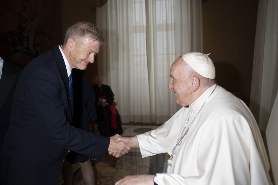 John James, Ed.D., professor of educational leadership, shakes hands with Pope Francis.
