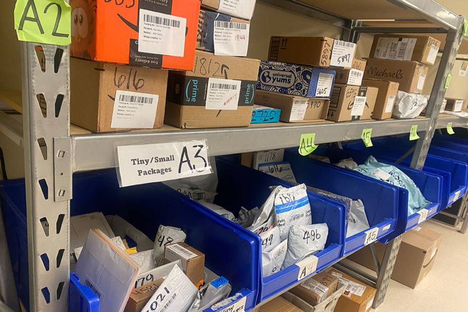 Shelves of packages in the SLU Mailroom