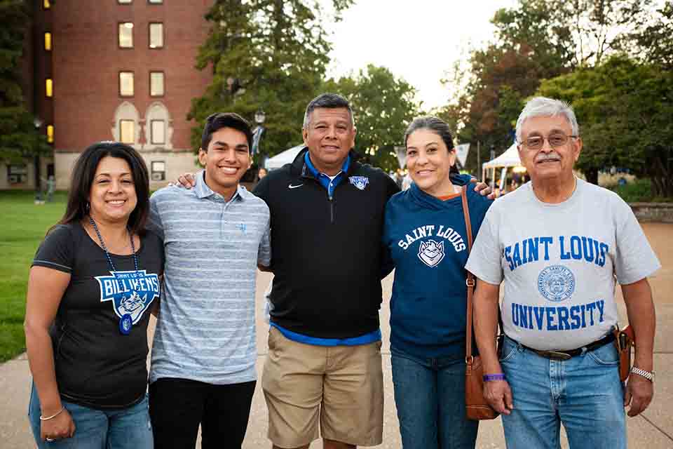 Family gathered outside dressed in SLU gear