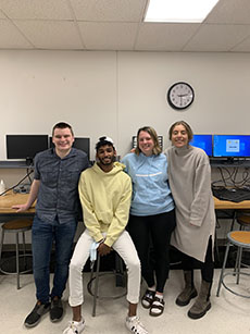 Kelly Campbell, William Kinczewski, Maria Madgalena Pereira Lopez and Rahul Ravichandran posed in a classroom